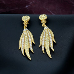 Vintage gold-tone clip-on earrings with jonquil and clear rhinestones in a feather-like Art Deco revival design; long dangle silhouette, 1970s style.