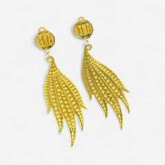 Vintage gold-tone clip-on earrings with jonquil and clear rhinestones in a feather-like Art Deco revival design; long dangle silhouette, 1970s style.
