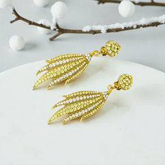Vintage gold-tone clip-on earrings with jonquil and clear rhinestones in a feather-like Art Deco revival design; long dangle silhouette, 1970s style.