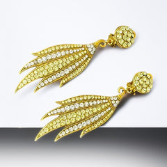 Vintage gold-tone clip-on earrings with jonquil and clear rhinestones in a feather-like Art Deco revival design; long dangle silhouette, 1970s style.