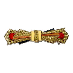 Vintage Art Deco style bow brooch with geometric enamel and resin design in black, gold, red, and white on silver tone base.