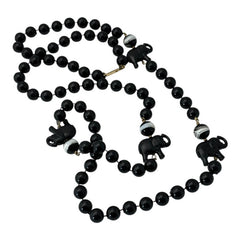 Vintage 1990s necklace featuring a symmetrical design with two elephant-shaped black beads, two black-and-white beads resembling banded agate, and a strand of 8mm black plastic beads in very good condition