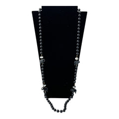 Vintage 1990s necklace featuring a symmetrical design with two elephant-shaped black beads, two black-and-white beads resembling banded agate, and a strand of 8mm black plastic beads in very good condition