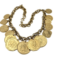 Vintage Franklin Mint Caribbean Coins necklace from the 1980s, featuring 14 uncirculated 24k gold-plated coins from Caribbean Islands on a textured chain.