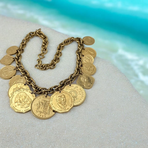 Vintage Franklin Mint Caribbean Coins necklace from the 1980s, featuring 14 uncirculated 24k gold-plated coins from Caribbean Islands on a textured chain.