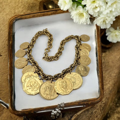 Vintage Franklin Mint Caribbean Coins necklace from the 1980s, featuring 14 uncirculated 24k gold-plated coins from Caribbean Islands on a textured chain.