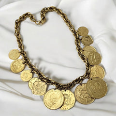 Vintage Franklin Mint Caribbean Coins necklace from the 1980s, featuring 14 uncirculated 24k gold-plated coins from Caribbean Islands on a textured chain.