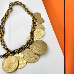 Vintage Franklin Mint Caribbean Coins necklace from the 1980s, featuring 14 uncirculated 24k gold-plated coins from Caribbean Islands on a textured chain.