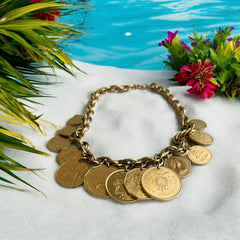 Vintage Franklin Mint Caribbean Coins necklace from the 1980s, featuring 14 uncirculated 24k gold-plated coins from Caribbean Islands on a textured chain.