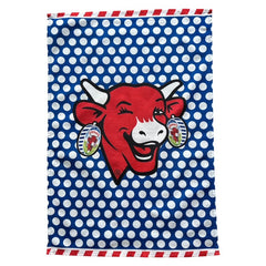 Coucke tea towel featuring a modern design of the red laughing cow with cheese box earrings on a blue background with white polka dots. Made of 100% cotton, blending playful charm with French culinary heritage.