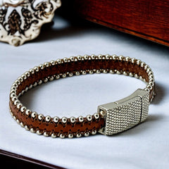 Erica Zap signed brown leather bracelet with silver-tone beaded edges and a textured magnetic clasp, modern artisan design in very good condition.