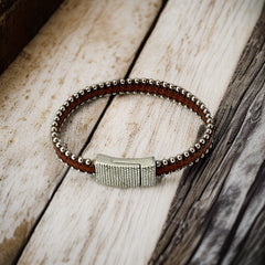 Erica Zap signed brown leather bracelet with silver-tone beaded edges and a textured magnetic clasp, modern artisan design in very good condition.