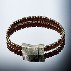 Erica Zap signed brown leather bracelet with silver-tone beaded edges and a textured magnetic clasp, modern artisan design in very good condition.