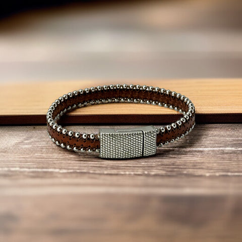 Erica Zap signed brown leather bracelet with silver-tone beaded edges and a textured magnetic clasp, modern artisan design in very good condition.