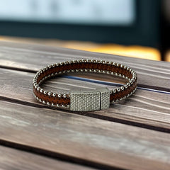 Erica Zap signed brown leather bracelet with silver-tone beaded edges and a textured magnetic clasp, modern artisan design in very good condition.