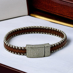 Erica Zap signed brown leather bracelet with silver-tone beaded edges and a textured magnetic clasp, modern artisan design in very good condition.