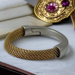 Signed Erica Zap bracelet featuring a woven 18K gold electroplated mesh band and a matte silver-tone crescent magnetic clasp. Artisan design with sculptural contrast between textures and tones. Shown from multiple angles to highlight clasp detail, mesh construction, and overall condition.