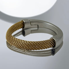 Signed Erica Zap bracelet featuring a woven 18K gold electroplated mesh band and a matte silver-tone crescent magnetic clasp. Artisan design with sculptural contrast between textures and tones. Shown from multiple angles to highlight clasp detail, mesh construction, and overall condition.