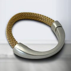 Signed Erica Zap bracelet featuring a woven 18K gold electroplated mesh band and a matte silver-tone crescent magnetic clasp. Artisan design with sculptural contrast between textures and tones. Shown from multiple angles to highlight clasp detail, mesh construction, and overall condition.
