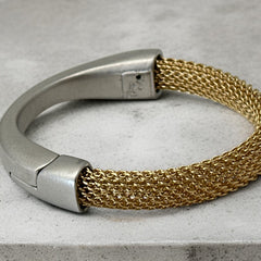 Signed Erica Zap bracelet featuring a woven 18K gold electroplated mesh band and a matte silver-tone crescent magnetic clasp. Artisan design with sculptural contrast between textures and tones. Shown from multiple angles to highlight clasp detail, mesh construction, and overall condition.