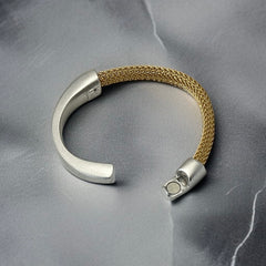 Signed Erica Zap bracelet featuring a woven 18K gold electroplated mesh band and a matte silver-tone crescent magnetic clasp. Artisan design with sculptural contrast between textures and tones. Shown from multiple angles to highlight clasp detail, mesh construction, and overall condition.