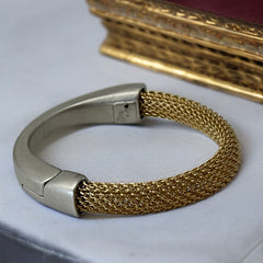 Signed Erica Zap bracelet featuring a woven 18K gold electroplated mesh band and a matte silver-tone crescent magnetic clasp. Artisan design with sculptural contrast between textures and tones. Shown from multiple angles to highlight clasp detail, mesh construction, and overall condition.