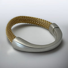 Signed Erica Zap bracelet featuring a woven 18K gold electroplated mesh band and a matte silver-tone crescent magnetic clasp. Artisan design with sculptural contrast between textures and tones. Shown from multiple angles to highlight clasp detail, mesh construction, and overall condition.