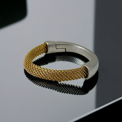Signed Erica Zap bracelet featuring a woven 18K gold electroplated mesh band and a matte silver-tone crescent magnetic clasp. Artisan design with sculptural contrast between textures and tones. Shown from multiple angles to highlight clasp detail, mesh construction, and overall condition.