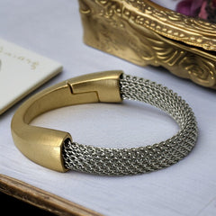 Signed Erica Zap bracelet featuring a rhodium-plated woven mesh band and a matte 18K gold electroplated crescent clasp. Sculptural magnetic closure with mixed-metal contrast. Shown from multiple angles to highlight clasp detail, mesh texture, and overall condition.