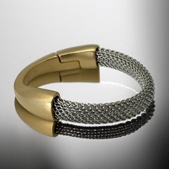 Signed Erica Zap bracelet featuring a rhodium-plated woven mesh band and a matte 18K gold electroplated crescent clasp. Sculptural magnetic closure with mixed-metal contrast. Shown from multiple angles to highlight clasp detail, mesh texture, and overall condition.