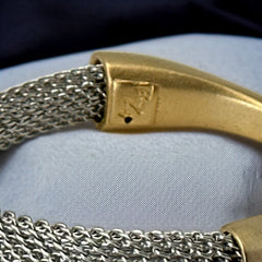 Signed Erica Zap bracelet featuring a rhodium-plated woven mesh band and a matte 18K gold electroplated crescent clasp. Sculptural magnetic closure with mixed-metal contrast. Shown from multiple angles to highlight clasp detail, mesh texture, and overall condition.