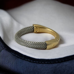 Signed Erica Zap bracelet featuring a rhodium-plated woven mesh band and a matte 18K gold electroplated crescent clasp. Sculptural magnetic closure with mixed-metal contrast. Shown from multiple angles to highlight clasp detail, mesh texture, and overall condition.