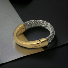 Signed Erica Zap bracelet featuring a rhodium-plated woven mesh band and a matte 18K gold electroplated crescent clasp. Sculptural magnetic closure with mixed-metal contrast. Shown from multiple angles to highlight clasp detail, mesh texture, and overall condition.