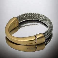Signed Erica Zap bracelet featuring a rhodium-plated woven mesh band and a matte 18K gold electroplated crescent clasp. Sculptural magnetic closure with mixed-metal contrast. Shown from multiple angles to highlight clasp detail, mesh texture, and overall condition.