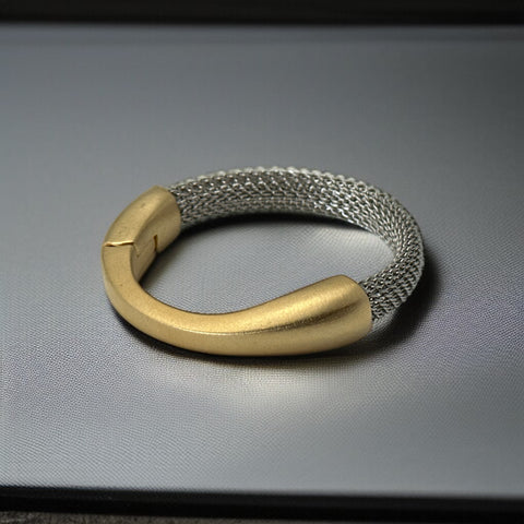 Signed Erica Zap bracelet featuring a rhodium-plated woven mesh band and a matte 18K gold electroplated crescent clasp. Sculptural magnetic closure with mixed-metal contrast. Shown from multiple angles to highlight clasp detail, mesh texture, and overall condition.