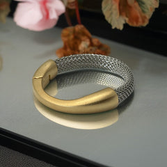 Signed Erica Zap bracelet featuring a rhodium-plated woven mesh band and a matte 18K gold electroplated crescent clasp. Sculptural magnetic closure with mixed-metal contrast. Shown from multiple angles to highlight clasp detail, mesh texture, and overall condition.