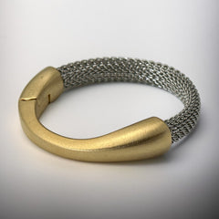 Signed Erica Zap bracelet featuring a rhodium-plated woven mesh band and a matte 18K gold electroplated crescent clasp. Sculptural magnetic closure with mixed-metal contrast. Shown from multiple angles to highlight clasp detail, mesh texture, and overall condition.