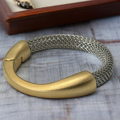 Signed Erica Zap bracelet featuring a rhodium-plated woven mesh band and a matte 18K gold electroplated crescent clasp. Sculptural magnetic closure with mixed-metal contrast. Shown from multiple angles to highlight clasp detail, mesh texture, and overall condition.