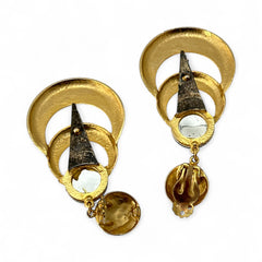 Vintage French modernist clip-on earrings with faceted blue round cabochons, layered gold and silver-tone metal crescents, and long sculptural dangles; shown from multiple angles to highlight texture, asymmetry, and mixed-metal design.