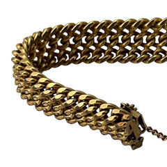 Vintage French gold-plated curb mesh bracelet from the 1960s/70s, featuring three soldered curb chains with a textured mesh design, a safety catch clasp with a safety chain, and intriguing marks (5M and an unclear jeweler's signature). Measures 8 inches long and showcases light vintage wear.