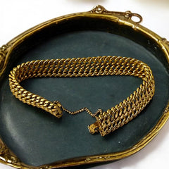 Vintage French gold-plated curb mesh bracelet from the 1960s/70s, featuring three soldered curb chains with a textured mesh design, a safety catch clasp with a safety chain, and intriguing marks (5M and an unclear jeweler's signature). Measures 8 inches long and showcases light vintage wear.