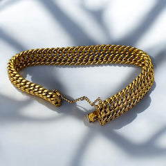 Vintage French gold-plated curb mesh bracelet from the 1960s/70s, featuring three soldered curb chains with a textured mesh design, a safety catch clasp with a safety chain, and intriguing marks (5M and an unclear jeweler's signature). Measures 8 inches long and showcases light vintage wear.