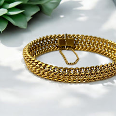 Vintage French gold-plated curb mesh bracelet from the 1960s/70s, featuring three soldered curb chains with a textured mesh design, a safety catch clasp with a safety chain, and intriguing marks (5M and an unclear jeweler's signature). Measures 8 inches long and showcases light vintage wear.