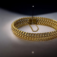 Vintage French gold-plated curb mesh bracelet from the 1960s/70s, featuring three soldered curb chains with a textured mesh design, a safety catch clasp with a safety chain, and intriguing marks (5M and an unclear jeweler's signature). Measures 8 inches long and showcases light vintage wear.