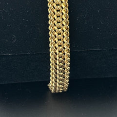 Vintage French gold-plated curb mesh bracelet from the 1960s/70s, featuring three soldered curb chains with a textured mesh design, a safety catch clasp with a safety chain, and intriguing marks (5M and an unclear jeweler's signature). Measures 8 inches long and showcases light vintage wear.