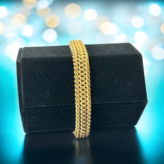 Vintage French gold-plated curb mesh bracelet from the 1960s/70s, featuring three soldered curb chains with a textured mesh design, a safety catch clasp with a safety chain, and intriguing marks (5M and an unclear jeweler's signature). Measures 8 inches long and showcases light vintage wear.