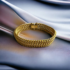 Vintage French gold-plated curb mesh bracelet from the 1960s/70s, featuring three soldered curb chains with a textured mesh design, a safety catch clasp with a safety chain, and intriguing marks (5M and an unclear jeweler's signature). Measures 8 inches long and showcases light vintage wear.