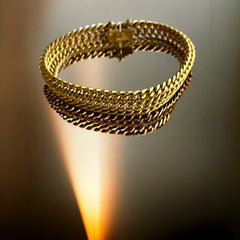 Vintage French gold-plated curb mesh bracelet from the 1960s/70s, featuring three soldered curb chains with a textured mesh design, a safety catch clasp with a safety chain, and intriguing marks (5M and an unclear jeweler's signature). Measures 8 inches long and showcases light vintage wear.