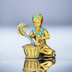 Vintage Hattie Carnegie snake charmer brooch with turquoise cabochons and blue rhinestones, gold tone metal, signed with copyright mark, 1960s figural costume jewelry.