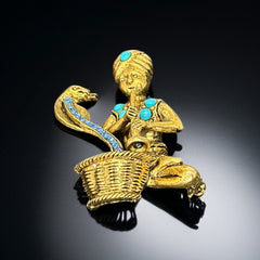 Vintage Hattie Carnegie snake charmer brooch with turquoise cabochons and blue rhinestones, gold tone metal, signed with copyright mark, 1960s figural costume jewelry.